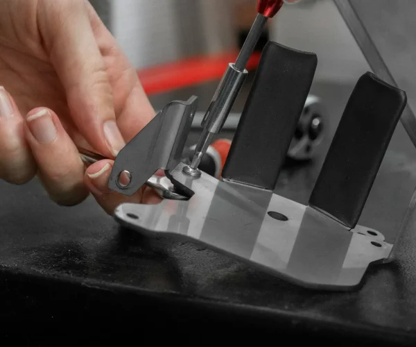 custom tooling Auckland metal component being removed from precision die during manufacturing process
