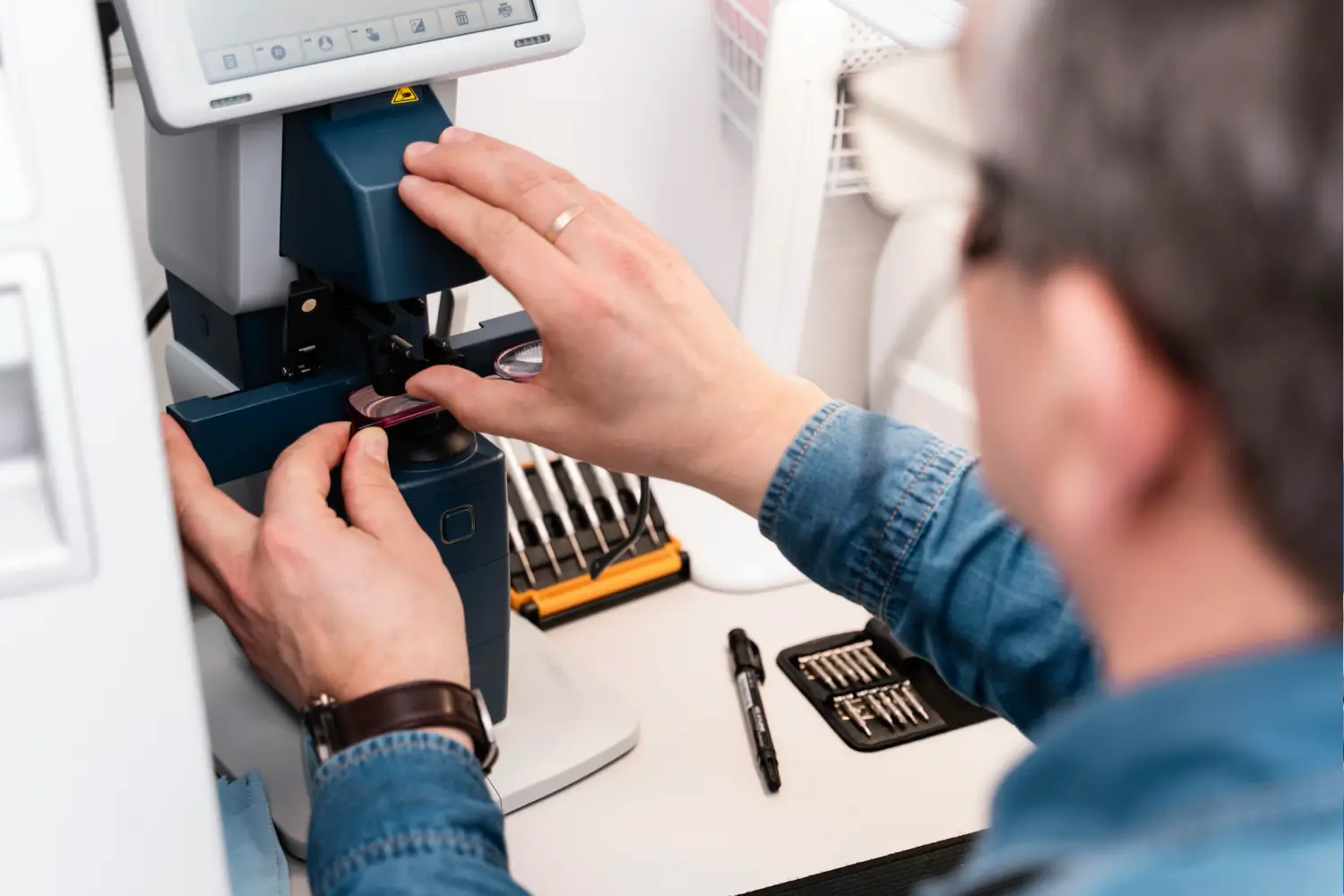 Skilled technician adjusting precision CNC machining equipment at Smart Tooling Ltd in Auckland